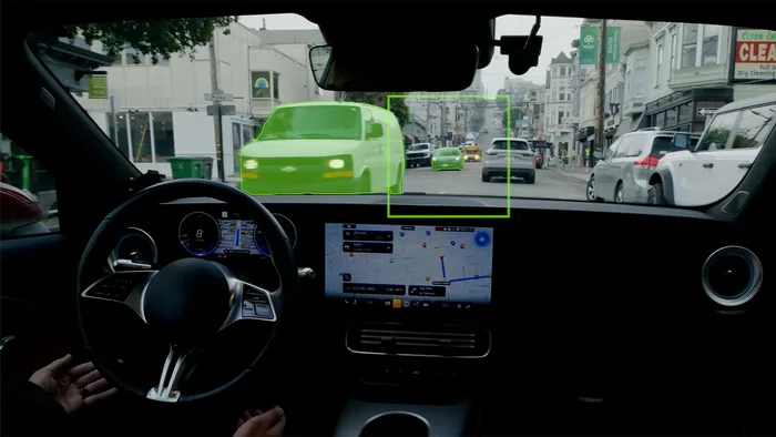 A driver's view with Alpamayo 2 Super segmenting vehicles ahead on a city street
